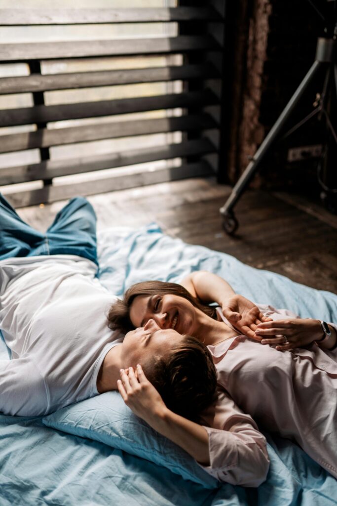 pexels-photo-12194485-12194485 Joyful couple embracing on a bed, enjoying a serene indoor moment.