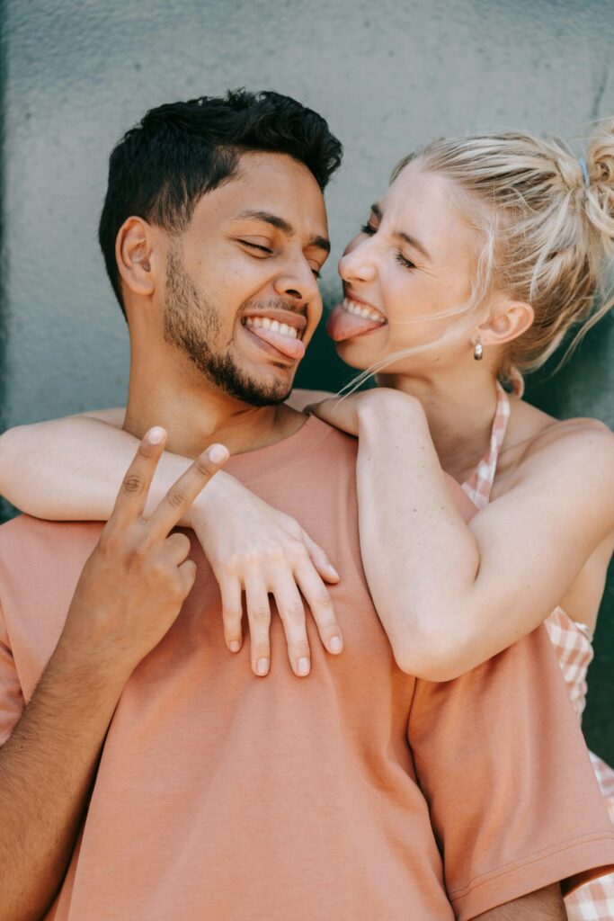 pexels-photo-9452057-9452057 A cheerful interracial couple playfully embraces, showing love and happiness.